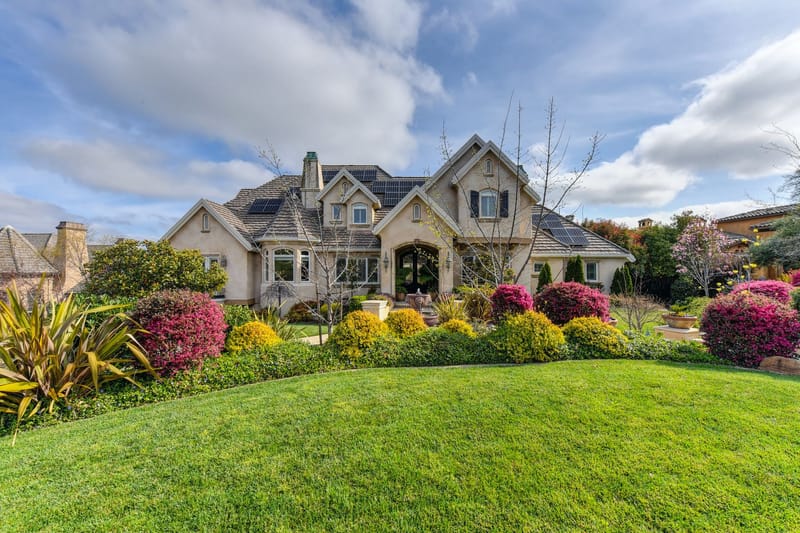 After: full flowering borders and a clean lawn in front of a house